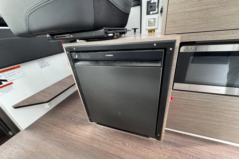  Yacht Photos Pics Interior of 2026 Jeanneau NC 895 Sport Series 2, featuring a compact kitchen area.