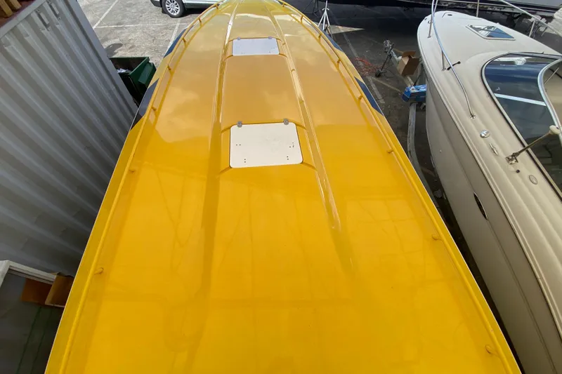  Yacht Photos Pics Yellow 1999 Fountain 47 Lightning boat top view in a marina.