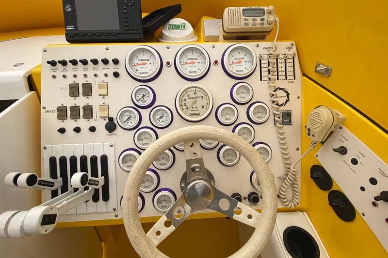  Yacht Photos Pics 1999 Fountain 47 Lightning boat dashboard with gauges, controls, and steering wheel.