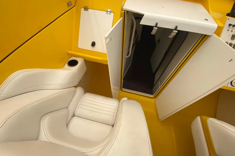  Yacht Photos Pics Interior of 1999 Fountain 47 Lightning boat with yellow and white seating.