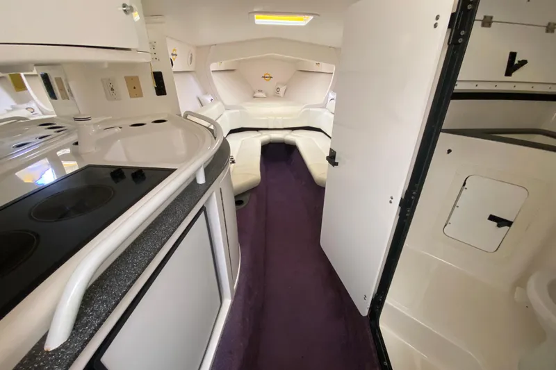  Yacht Photos Pics Interior of a 1999 Fountain 47 Lightning boat with white seating and kitchenette.