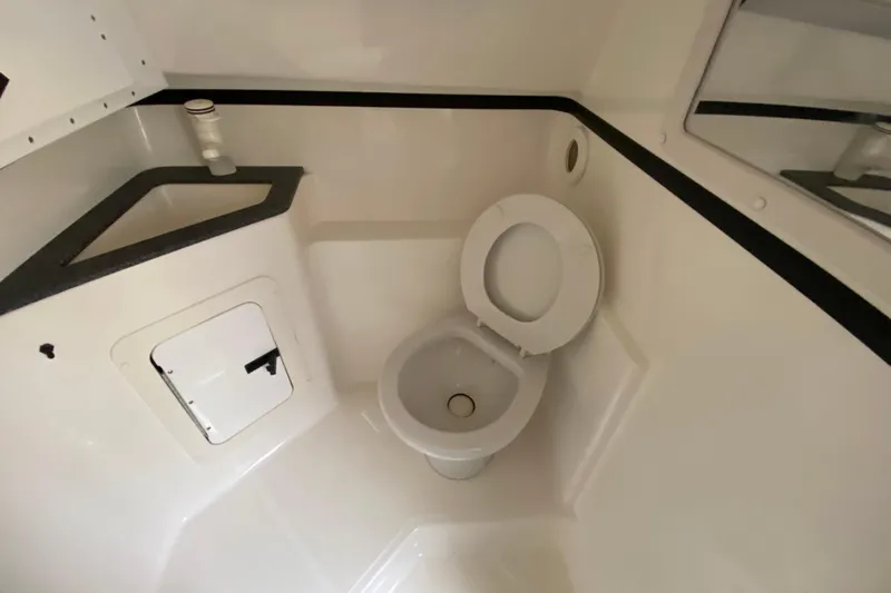  Yacht Photos Pics 1999 Fountain 47 Lightning boat bathroom with toilet and sink.