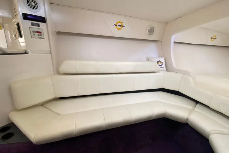 Yacht Photos Pics Interior of 1999 Fountain 47 Lightning boat with white leather seating and branded decor.