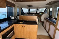 Interior of 2017 Azimut Magellano 53 yacht with modern kitchen and panoramic windows.