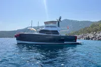 Azimut Magellano 53 yacht, 2017 model, anchored in scenic coastal waters.