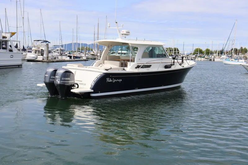 Polo Lounge Yacht Photos Pics 2020 Back Cove 34O boat with twin Yamaha engines in a marina setting.