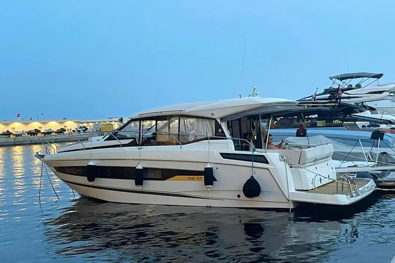  Yacht Photos Pics 2021 Jeanneau NC 37 yacht docked at marina during twilight.