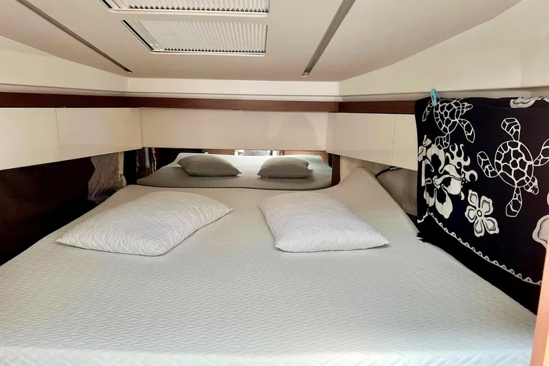  Yacht Photos Pics Interior cabin of 2021 Jeanneau NC 37 with comfortable bedding and decorative accents.