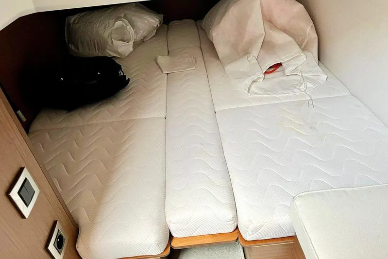  Yacht Photos Pics Cabin interior of 2021 Jeanneau NC 37 with twin beds and bedding.