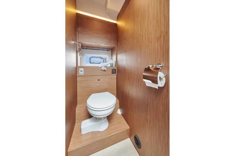  Yacht Photos Pics Modern bathroom in 2021 Jeanneau NC 37 yacht with wooden accents and compact design.