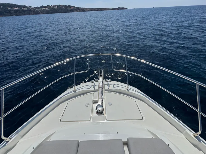  Yacht Photos Pics Bow view of 2023 Prestige 460 yacht cruising on open sea.