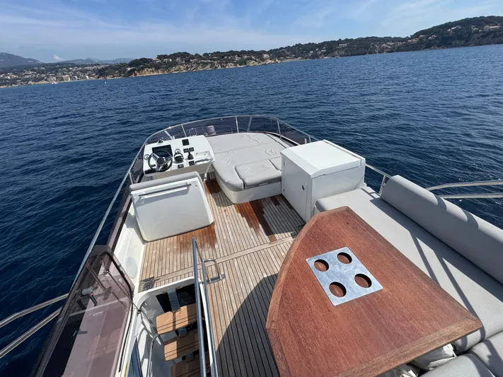  Yacht Photos Pics Luxurious 2023 Prestige 460 yacht deck with seating, table, and ocean view.