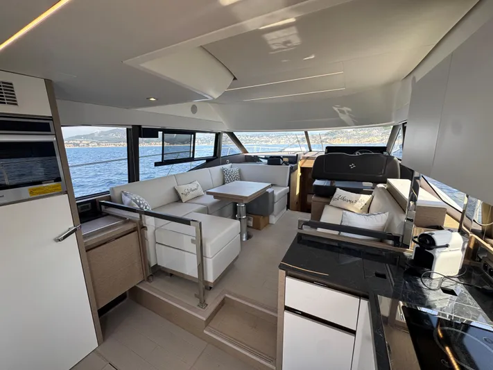  Yacht Photos Pics Luxurious interior of 2023 Prestige 460 yacht with modern seating and panoramic windows.
