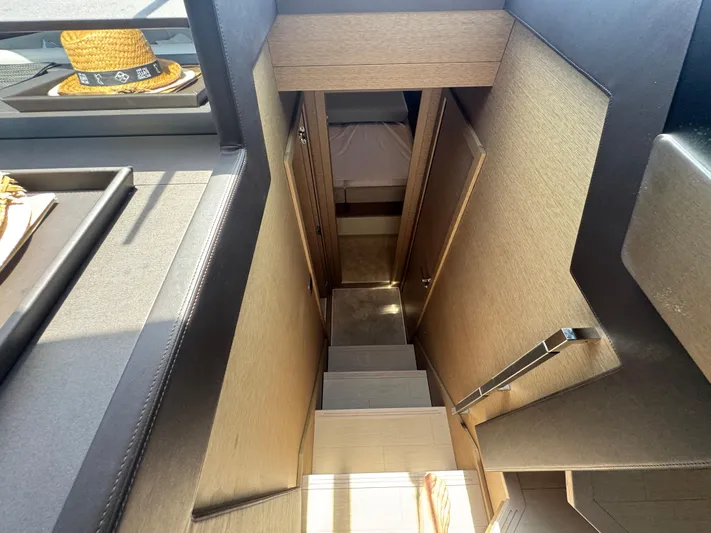  Yacht Photos Pics Interior view of 2023 Prestige 460 yacht, featuring a staircase leading to a cozy cabin.