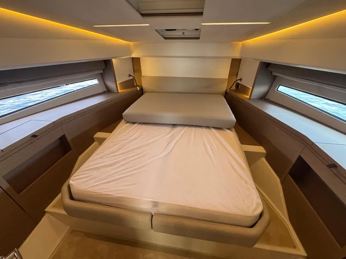  Yacht Photos Pics Luxurious bedroom interior of 2023 Prestige 460 yacht with modern lighting and windows.