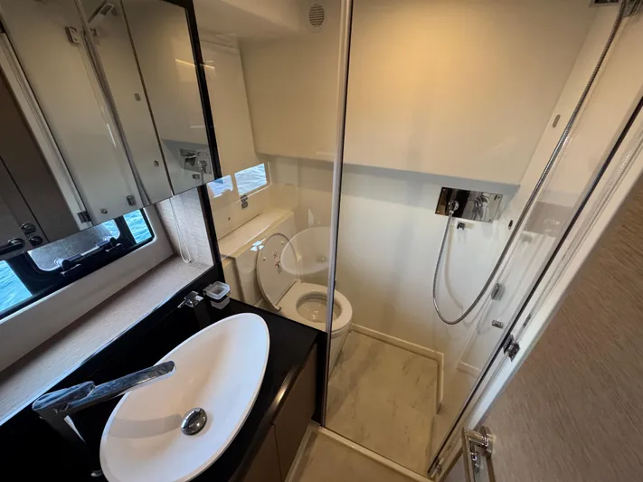  Yacht Photos Pics Modern bathroom in 2023 Prestige 460 yacht with sleek fixtures and glass shower.