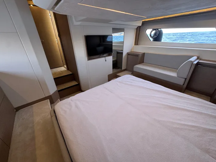  Yacht Photos Pics Luxurious interior of 2023 Prestige 460 yacht with bed, TV, and ocean view.