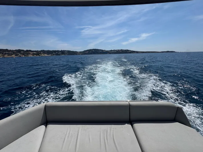  Yacht Photos Pics Luxury yacht Prestige 460 cruising on open sea, leaving a foamy wake behind.