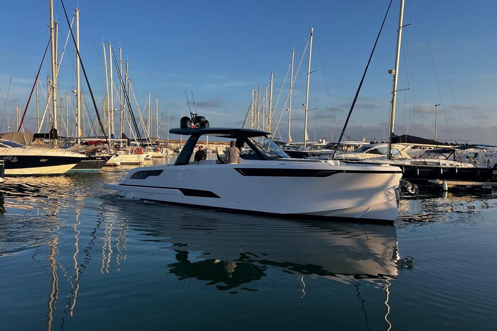 2025 Level Yachts 43 ST in marina, sleek design, calm water reflection.