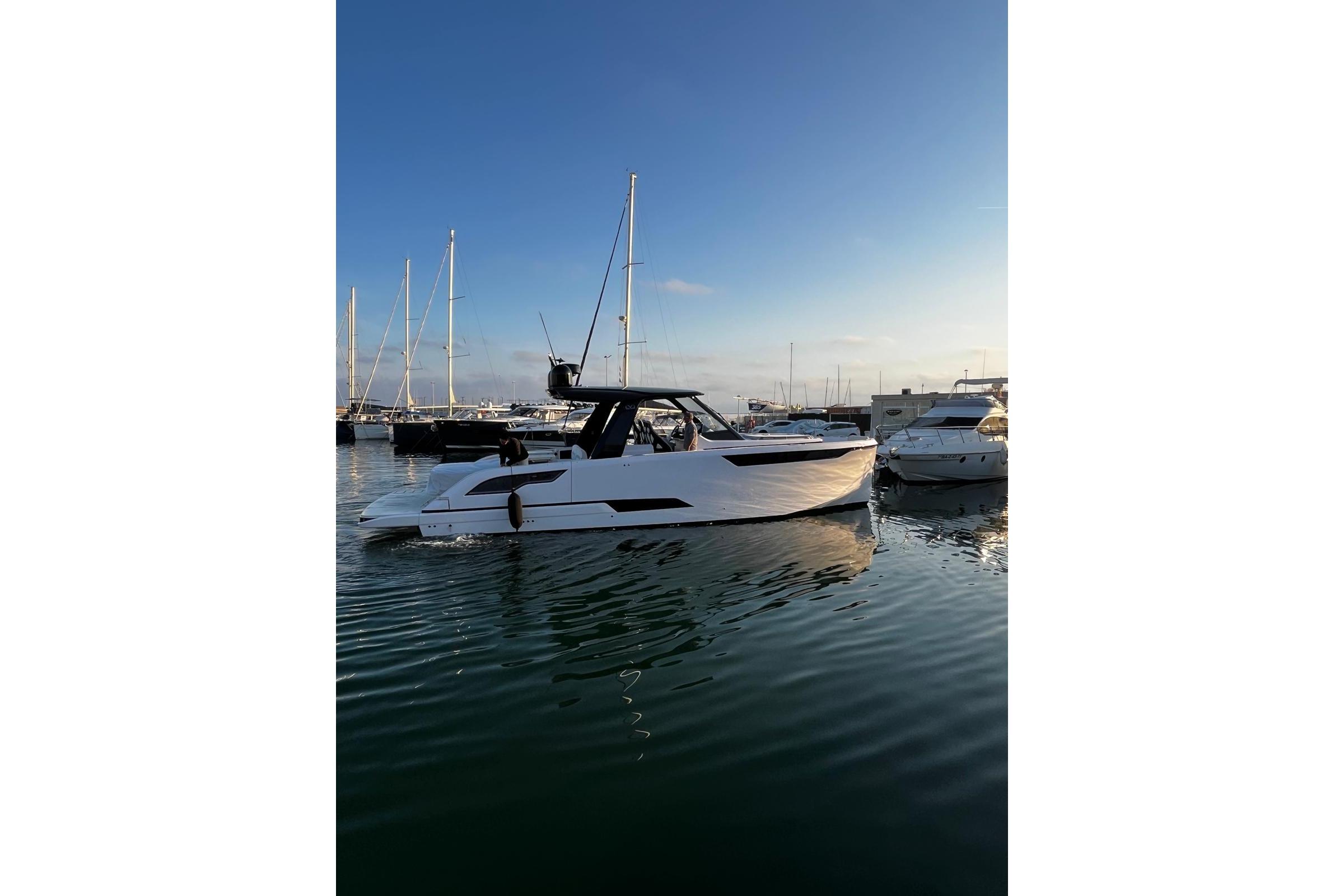 2025 Level Yachts 43 ST in marina, sleek design, calm waters, clear sky.