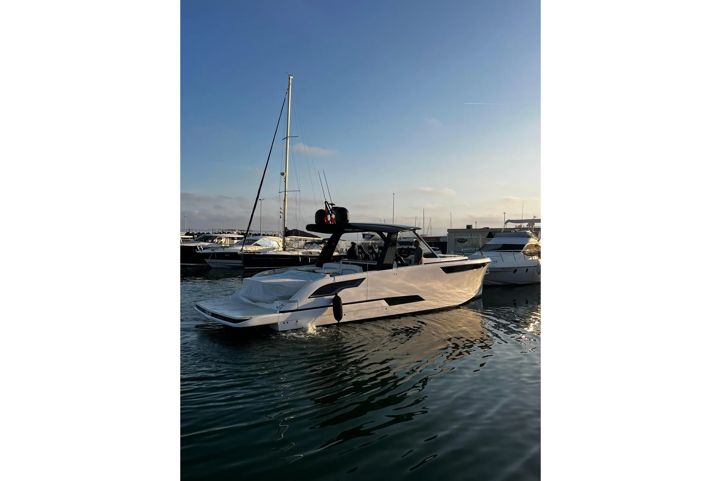 2025 Level Yachts 43 ST in marina at sunset, sleek design, calm waters.