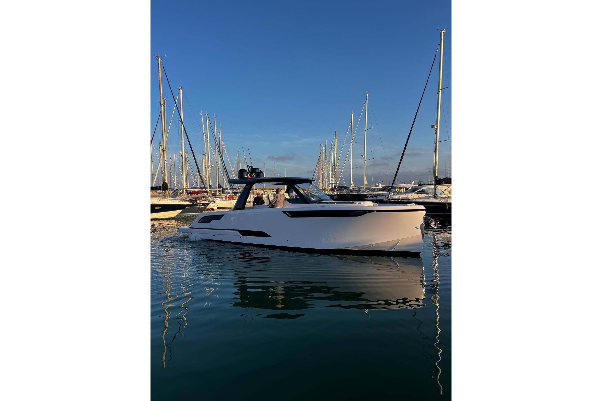 2025 Level Yachts 43 ST in marina, sleek design, calm waters, clear sky.