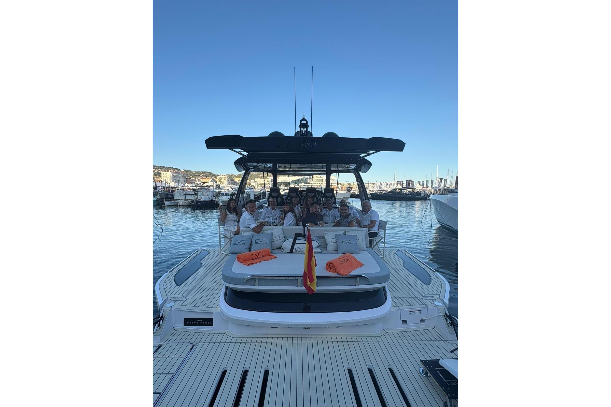 2025 Level Yachts 43 ST with passengers, docked in a marina under clear blue skies.