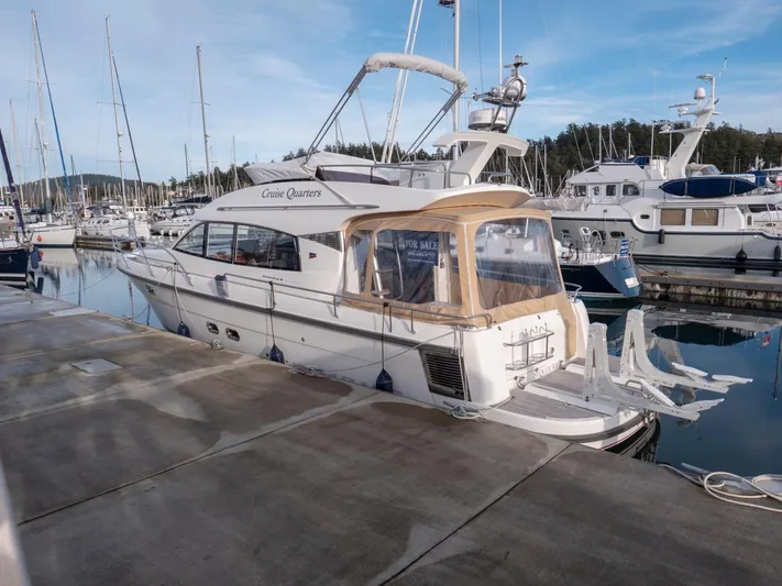 Seahawk Yacht Photos Pics 2017 Nimbus 405 Flybridge yacht docked at marina, clear sky, calm waters.
