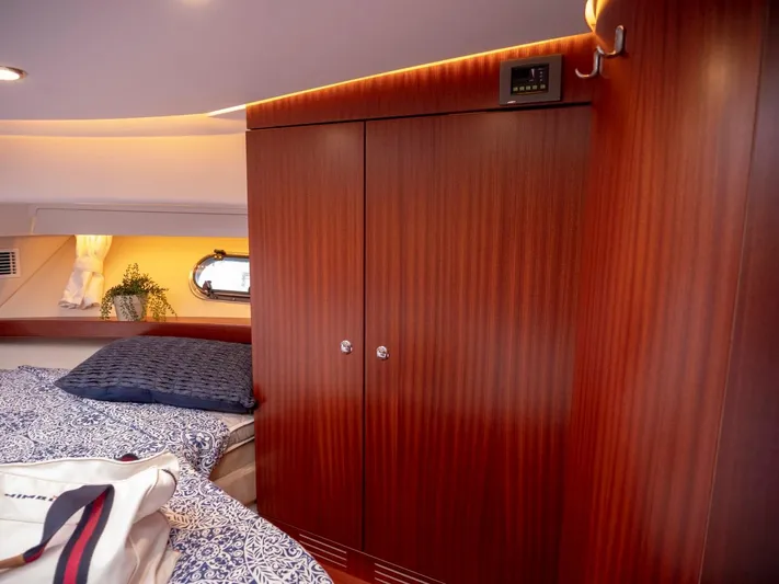 Seahawk Yacht Photos Pics Luxurious cabin interior of 2017 Nimbus 405 Flybridge with wooden wardrobe and cozy bedding.