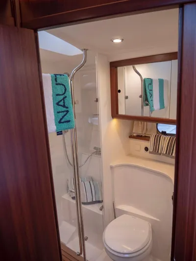 Seahawk Yacht Photos Pics Bathroom interior of 2017 Nimbus 405 Flybridge yacht, featuring modern fixtures and wooden accents.