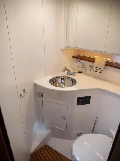 Seahawk Yacht Photos Pics Bathroom interior of 2017 Nimbus 405 Flybridge yacht, featuring modern sink and toilet.