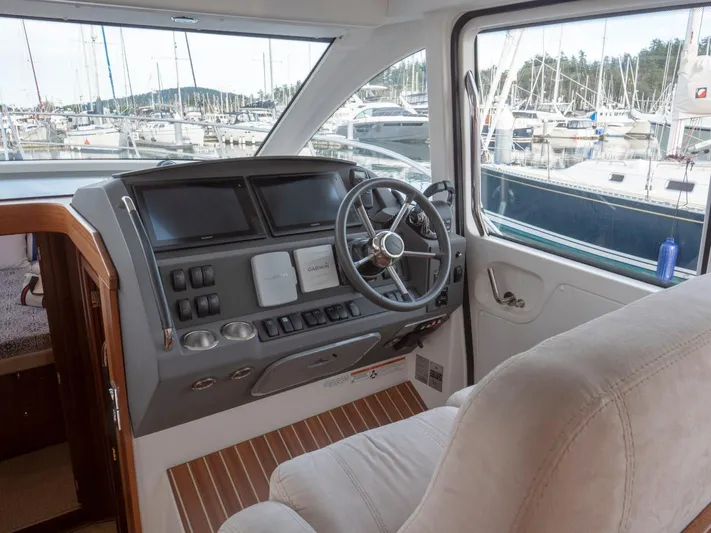 Seahawk Yacht Photos Pics Interior helm of 2017 Nimbus 405 Flybridge yacht with modern controls and marina view.
