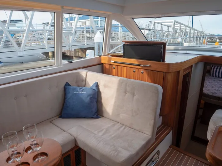 Seahawk Yacht Photos Pics Interior of 2017 Nimbus 405 Flybridge yacht with cozy seating and a small TV.