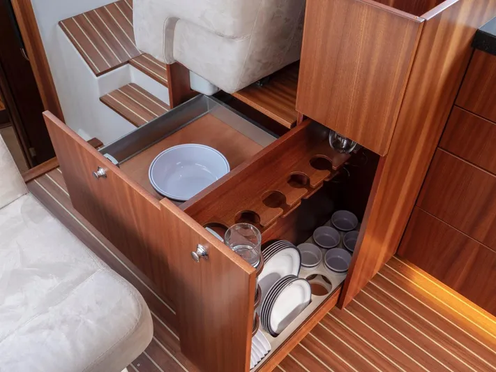 Seahawk Yacht Photos Pics Luxurious wooden cabinetry with organized dish storage on Nimbus 405 Flybridge, 2017 model.