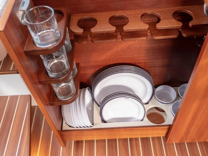 Seahawk Yacht Photos Pics Wooden cabinet with glassware and plates on a Nimbus 405 Flybridge, 2017 model.