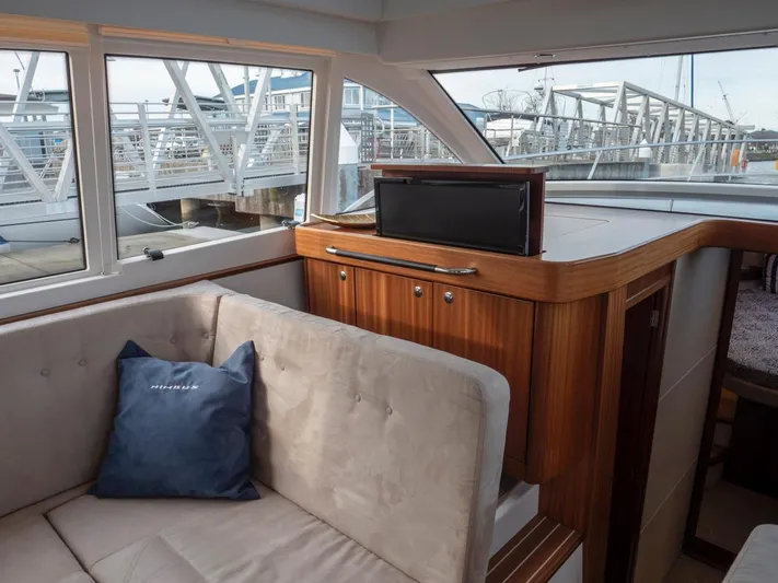 Seahawk Yacht Photos Pics Interior of 2017 Nimbus 405 Flybridge yacht with plush seating and a retractable TV.