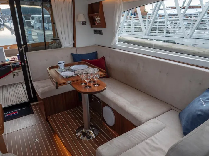 Seahawk Yacht Photos Pics Interior of 2017 Nimbus 405 Flybridge yacht with cozy seating and elegant table setting.