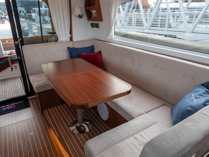 Seahawk Yacht Photos Pics Luxurious interior of 2017 Nimbus 405 Flybridge with elegant wood table and plush seating.
