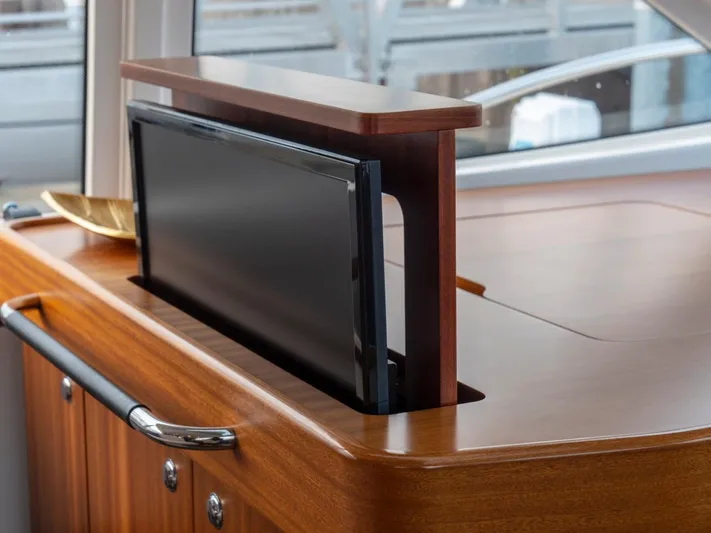 Seahawk Yacht Photos Pics Pop-up TV on Nimbus 405 Flybridge yacht, 2017 model, with elegant wooden cabinetry.