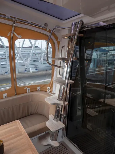 Seahawk Yacht Photos Pics Interior of 2017 Nimbus 405 Flybridge yacht with sleek metal staircase and cozy seating area.