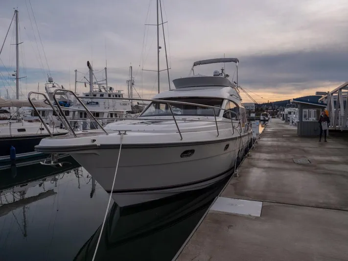 Seahawk Yacht Photos Pics 2017 Nimbus 405 Flybridge yacht docked at marina during sunset.