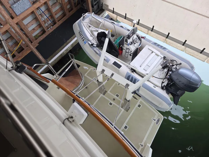 Pazzaz Yacht Photos Pics 1985 Chris-Craft 500 Constellation Motor Yacht with dinghy in dock.