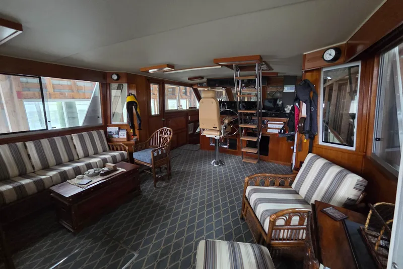 Pazzaz Yacht Photos Pics Interior of 1985 Chris-Craft 500 Constellation Motor Yacht with striped seating and wooden accents.