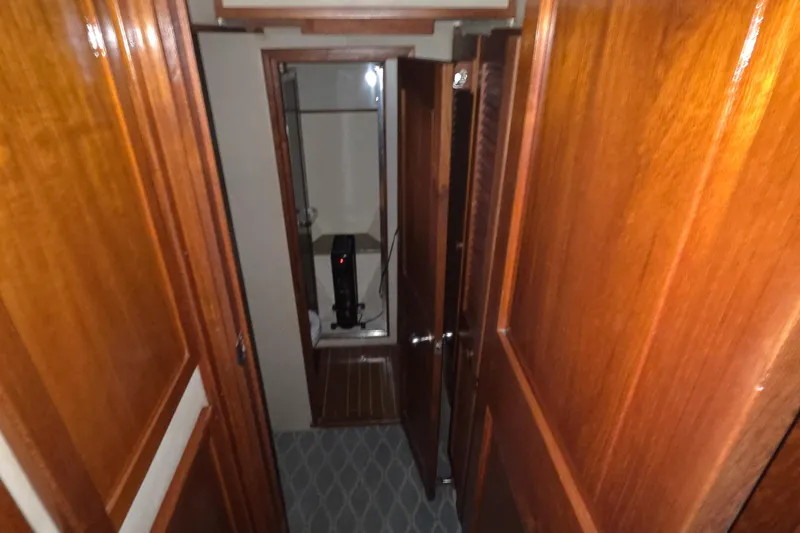 Pazzaz Yacht Photos Pics 1985 Chris-Craft 500 Constellation Motor Yacht interior hallway with wooden paneling.