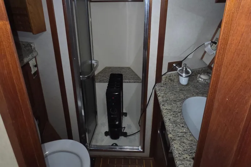 Pazzaz Yacht Photos Pics 1985 Chris-Craft 500 Constellation Motor Yacht bathroom with granite countertops and shower.