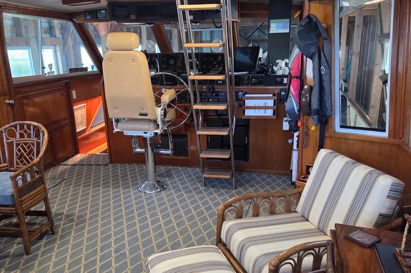 Pazzaz Yacht Photos Pics Interior of 1985 Chris-Craft 500 Constellation Motor Yacht with helm and seating area.