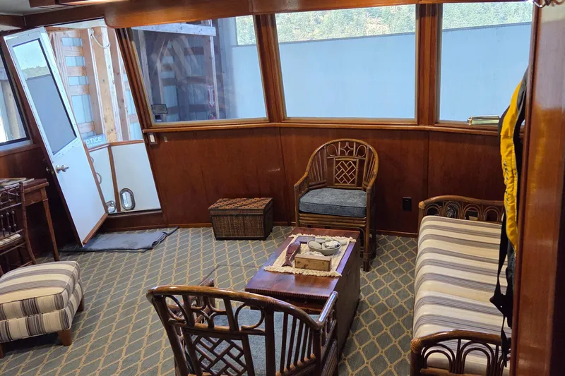 Pazzaz Yacht Photos Pics Interior of 1985 Chris-Craft 500 Constellation Motor Yacht with wooden furniture and striped upholstery.