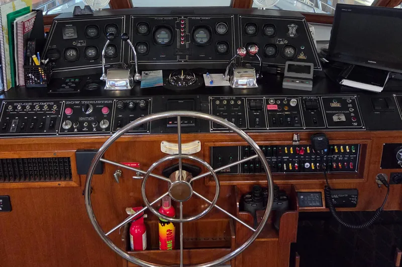 Pazzaz Yacht Photos Pics 1985 Chris-Craft 500 Constellation Motor Yacht helm with steering wheel and control panels.