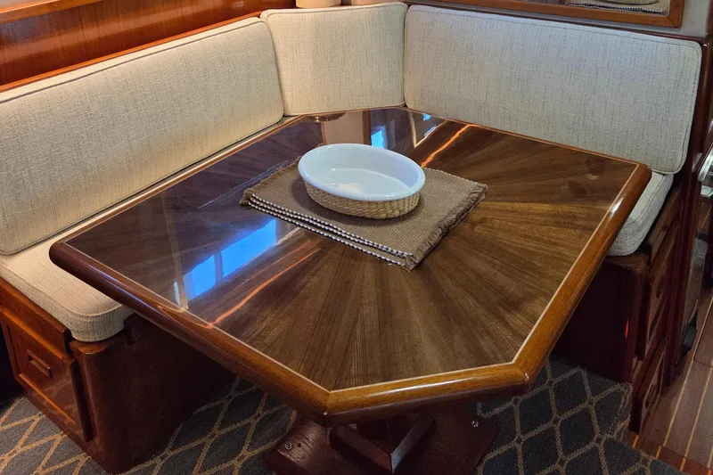 Pazzaz Yacht Photos Pics Luxurious dining area in 1985 Chris-Craft 500 Constellation Motor Yacht with elegant wood table.