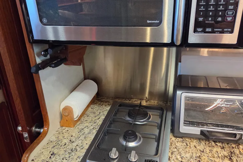 Pazzaz Yacht Photos Pics Kitchen area of 1985 Chris-Craft 500 Constellation Motor Yacht with stove and appliances.